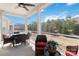Relaxing screened-in porch features a ceiling fan and outdoor furniture for enjoying the backyard view at 7336 Overjoyed Xing, Charlotte, NC 28215