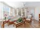 Bright sitting area with wicker furniture, and a ceiling fan, creating a relaxing space with abundant natural light at 7336 Overjoyed Xing, Charlotte, NC 28215