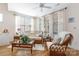 Cozy sitting area with wicker furniture, and a ceiling fan, creating a relaxing space with abundant natural light at 7336 Overjoyed Xing, Charlotte, NC 28215