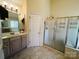 Bathroom with a glass-enclosed shower, soaking tub, vanity, and tile flooring at 7700 Sedgebrook E Dr, Stanley, NC 28164