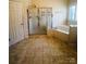 Spacious bathroom featuring a corner soaking tub and separate shower at 7700 Sedgebrook E Dr, Stanley, NC 28164