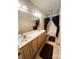 Bathroom featuring a double sink vanity, large mirror, and a shower with brown curtains at 7700 Sedgebrook E Dr, Stanley, NC 28164