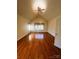 Spacious bedroom with hardwood floors, vaulted ceilings, and large windows with curtains at 7700 Sedgebrook E Dr, Stanley, NC 28164