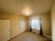Bedroom featuring neutral carpeting, double closets, and a bright window at 7700 Sedgebrook E Dr, Stanley, NC 28164