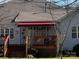 Outdoor deck featuring an awning for shade in a backyard setting at 7700 Sedgebrook E Dr, Stanley, NC 28164