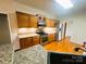 Modern kitchen showcasing stainless steel appliances, wood cabinets, and granite counters at 7700 Sedgebrook E Dr, Stanley, NC 28164