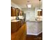 Well-lit kitchen featuring wood floors, granite countertops, tile backsplash, and stainless steel appliances at 7700 Sedgebrook E Dr, Stanley, NC 28164