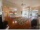 Open living room showcasing hardwood floors, fireplace, and open layout to kitchen and dining area at 7700 Sedgebrook E Dr, Stanley, NC 28164