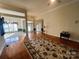 Open-concept living room with hardwood floors and a decorative rug at 7700 Sedgebrook E Dr, Stanley, NC 28164