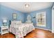 Comfortable bedroom features a floral bedspread, woven furniture, and a bright window at 800 River Oaks Ln, Charlotte, NC 28226