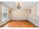 Bright dining room boasts a parquet floor, window, chandelier, and neutral colors at 800 River Oaks Ln, Charlotte, NC 28226