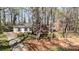 Aerial view of a one-story home surrounded by mature trees and landscaping, with a neighboring brick home visible at 800 River Oaks Ln, Charlotte, NC 28226