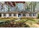 Charming one-story home featuring a brick facade, blue shutters, a well-manicured lawn, and a welcoming blue front door at 800 River Oaks Ln, Charlotte, NC 28226