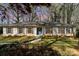 Charming one-story home featuring a brick facade, blue shutters, a well-manicured lawn, and a welcoming blue front door at 800 River Oaks Ln, Charlotte, NC 28226