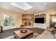 Cozy living room featuring a brick fireplace, built-in shelving, and French doors leading to the outdoors at 800 River Oaks Ln, Charlotte, NC 28226