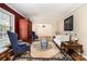 Elegant living room with a decorative rug, stylish seating, and a glimpse into an adjacent room with a chandelier at 800 River Oaks Ln, Charlotte, NC 28226
