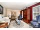 Comfortable living room with a patterned rug, blue chairs, and a stylish display cabinet at 800 River Oaks Ln, Charlotte, NC 28226