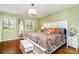 Bright bedroom features hardwood floors, a decorative mirror, and a colorful bedspread at 800 River Oaks Ln, Charlotte, NC 28226