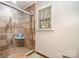 Modern bathroom with glass-enclosed tile shower, and window at 800 River Oaks Ln, Charlotte, NC 28226