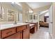 Bright bathroom featuring double sinks, white countertops, and cherry-stained cabinets at 808 Wynnshire Dr # A, Hickory, NC 28601
