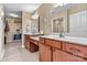 Large bathroom featuring double sinks, white countertops, cherry-stained cabinets, and a walk-in closet at 808 Wynnshire Dr # A, Hickory, NC 28601