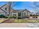 Front exterior of a charming home featuring stone and siding, an arched window and landscaping at 808 Wynnshire Dr # A, Hickory, NC 28601