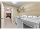 Functional laundry room with modern washer and dryer units plus built-in shelving for storage at 808 Wynnshire Dr # A, Hickory, NC 28601