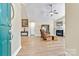 Bright living room featuring wood floors, fireplace, and ceiling fan at 808 Wynnshire Dr # A, Hickory, NC 28601