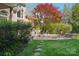 Landscaped backyard with a stone patio, fire pit, and lush greenery, perfect for outdoor entertaining and relaxation at 820 Hampshire Hill Rd # 106, Matthews, NC 28105