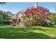 Expansive backyard with lush lawn, patio area, firepit, and a charming screened-in porch at 820 Hampshire Hill Rd # 106, Matthews, NC 28105