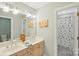 Bright bathroom with double sinks, a large mirror, and a separate shower area for convenience and comfort at 820 Hampshire Hill Rd # 106, Matthews, NC 28105