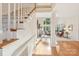 Bright and open foyer with a staircase and hardwood floors leading into the living area at 820 Hampshire Hill Rd # 106, Matthews, NC 28105