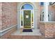 Inviting front entrance with an arched doorway and decorative floral arrangement at 820 Hampshire Hill Rd # 106, Matthews, NC 28105