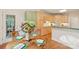 Eat-in kitchen features a wooden table with seating next to updated appliances and countertop space at 820 Hampshire Hill Rd # 106, Matthews, NC 28105