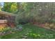 Landscaped yard with a stone path leading to a screened porch and flourishing green vegetation at 820 Hampshire Hill Rd # 106, Matthews, NC 28105