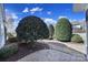Well-maintained backyard with lush landscaping, trees, and a paver patio at 9332 Whistling Straits Dr, Fort Mill, SC 29707