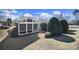 Inviting backyard featuring a screened-in porch and beautiful, mature landscaping and manicured hedges at 9332 Whistling Straits Dr, Fort Mill, SC 29707