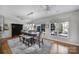 Sunlit dining room featuring modern lighting, ample seating, and large windows overlooking the landscaped yard at 9332 Whistling Straits Dr, Fort Mill, SC 29707