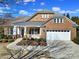 Charming brick home with a stone facade, manicured landscaping, and a two-car garage at 9332 Whistling Straits Dr, Fort Mill, SC 29707