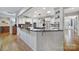 Bright kitchen boasts a spacious island with granite countertops, modern appliances, and ample storage space at 9332 Whistling Straits Dr, Fort Mill, SC 29707