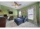 Comfortable living room with green walls, ceiling fan and nice furniture at 9332 Whistling Straits Dr, Fort Mill, SC 29707