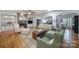 Inviting living room featuring a cozy fireplace, built-in shelving, hardwood floors, and comfortable seating at 9332 Whistling Straits Dr, Fort Mill, SC 29707
