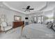 Bright main bedroom features a large window, hardwood floors, and cozy chair perfect for relaxing at 9332 Whistling Straits Dr, Fort Mill, SC 29707
