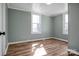 Bright bedroom featuring wood-look floors and freshly painted walls with natural lighting at 97 Central Ave, China Grove, NC 28023