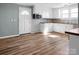 Bright kitchen with white cabinets, butcher block countertops, and wood-look floors at 97 Central Ave, China Grove, NC 28023