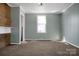 Spacious living room with a cozy fireplace and plush carpeting for ultimate comfort at 97 Central Ave, China Grove, NC 28023