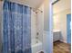 Cozy bathroom with a tub, shower, and a blue patterned shower curtain at 9921 Ridgemore Dr, Charlotte, NC 28277