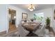 Inviting dining area featuring a stylish table setting and modern chandelier that create a welcoming atmosphere at 9921 Ridgemore Dr, Charlotte, NC 28277