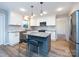 Modern kitchen features granite countertops, stainless appliances, island and eat-in breakfast bar at 9921 Ridgemore Dr, Charlotte, NC 28277