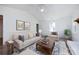 Bright living room with a ceiling fan, neutral colored walls, and a comfortable couch on an ornamental rug at 9921 Ridgemore Dr, Charlotte, NC 28277